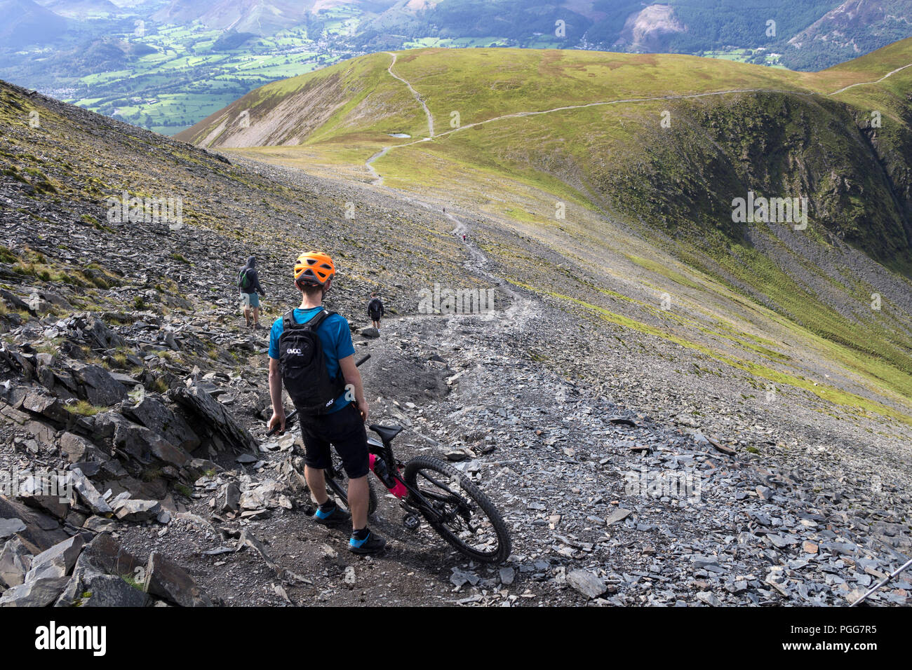 Mountain Biker on the Path Leading to Carlside from the Top of Skiddaw, Lake District, Cumbria, UK. Stock Photo