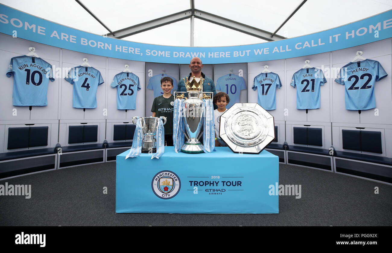 Manchester City fans pose with last season trophy haul at City Festival at the Academy Stadium, Manchester. PRESS ASSOCIATION Photo. Picture date: Sunday August 26, 2018. See PA story SOCCER Man City. Photo credit should read: Nick Potts/PA Wire Stock Photo