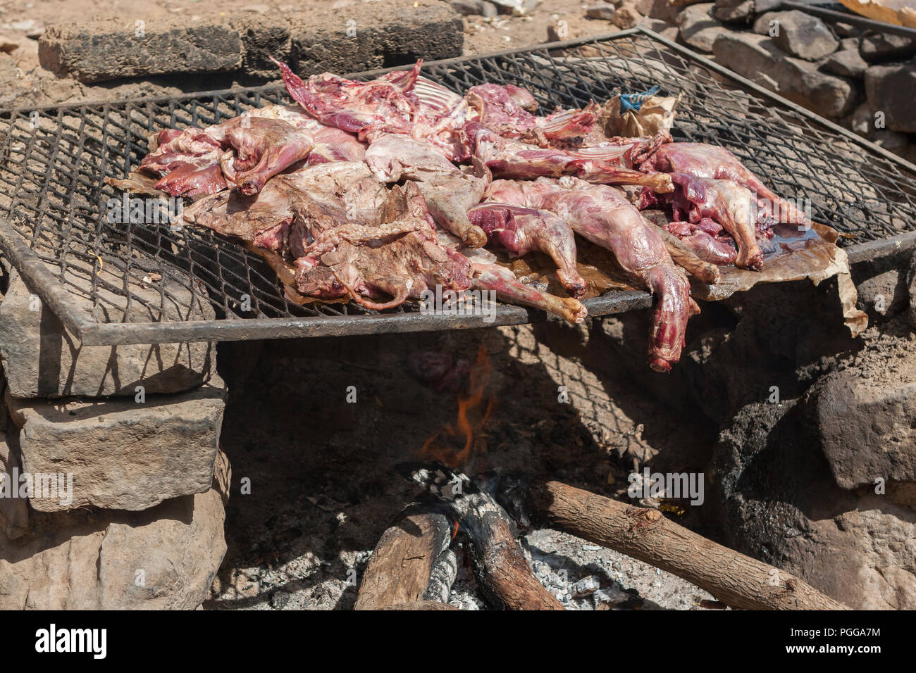 Raw meat cooking on a grill in a street market in Mali, Africa Stock Photo