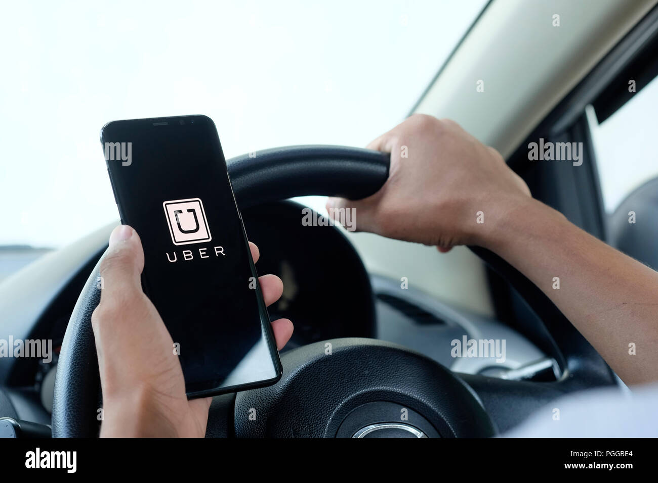 CHIANG MAI,THAILAND - AUGEST 13, 2018 : A man hand holding Uber 