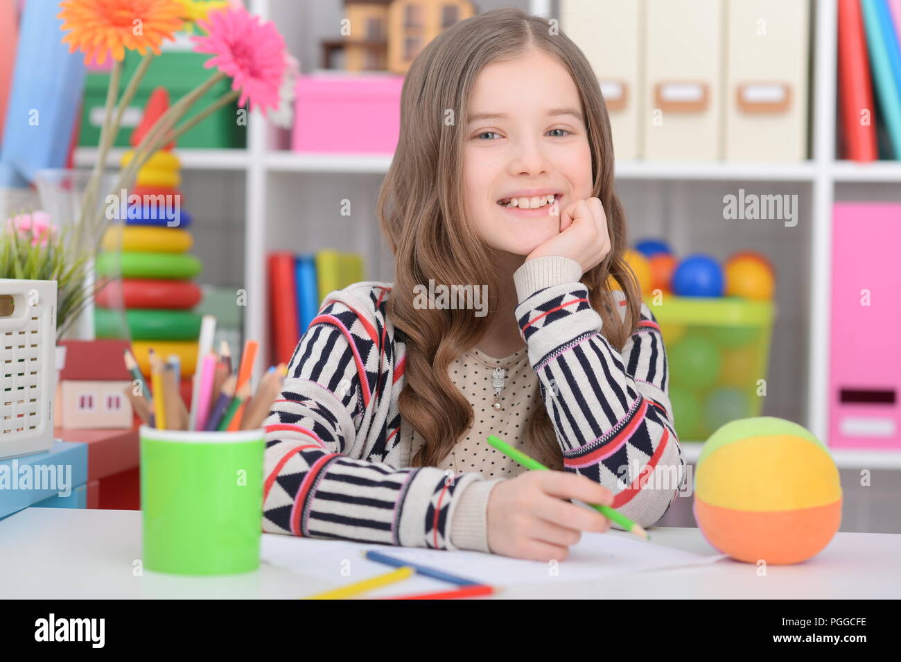 Portrait of a cute little girl doing homework Stock Photo - Alamy