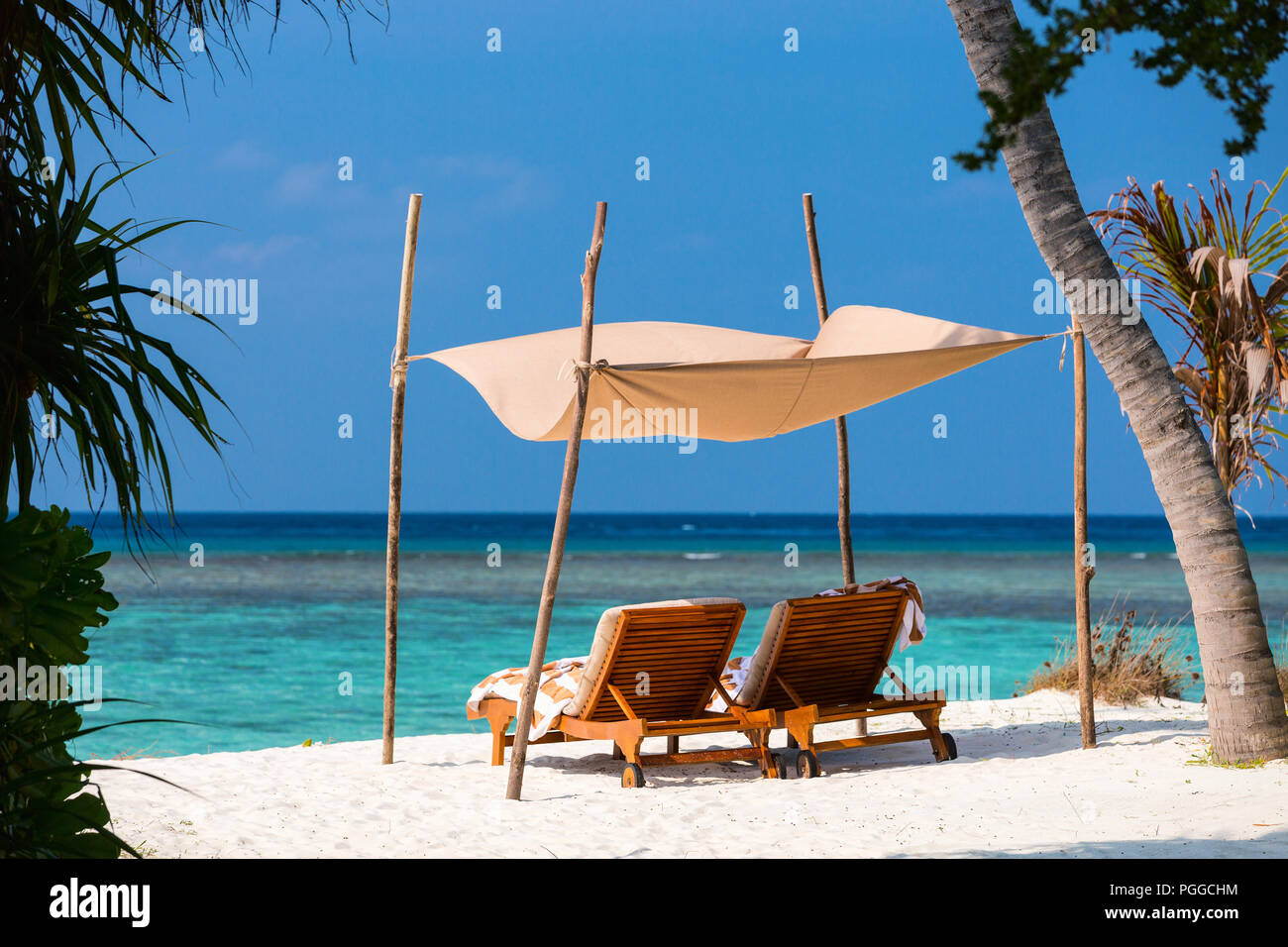 Wooden Lounge Chairs On A Beautiful Tropical Beach At Maldives Stock Photo Alamy