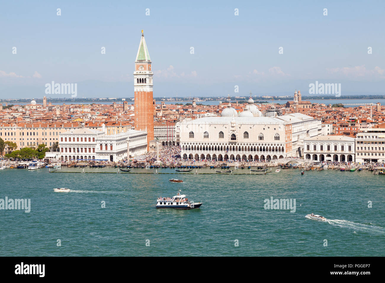 Aerial view Doges Palace and St Marks Campanile, Venice, Veneto, Italy with a view over the rooftops of the city and lagoon to the mainland. Tourist b Stock Photo