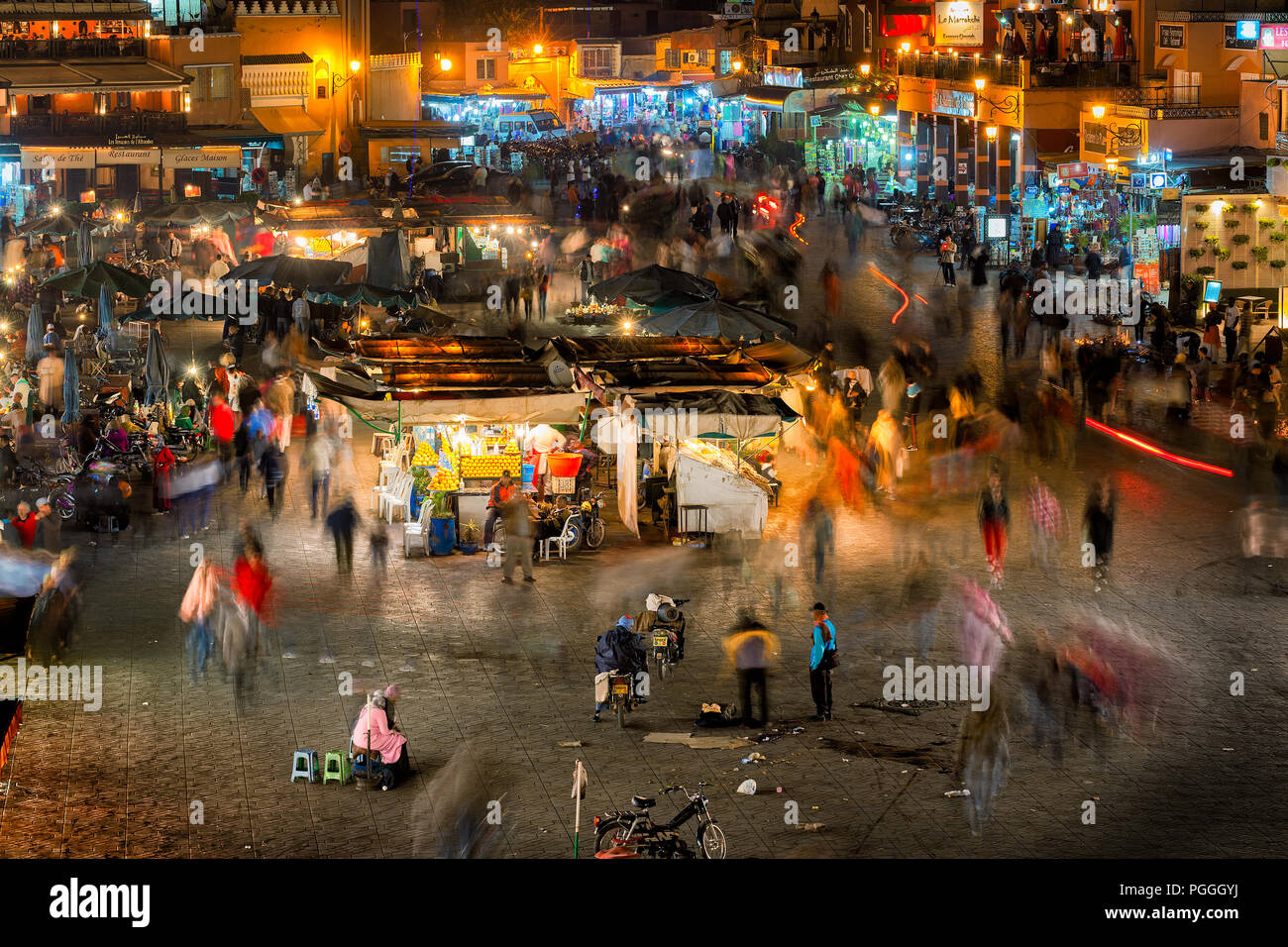 MOROCCO-DEC 24, 2012:The busy night market in the famous medina, a UNESCO site, in Marrakech, Morocco. In the evening the square fills with food stand Stock Photo