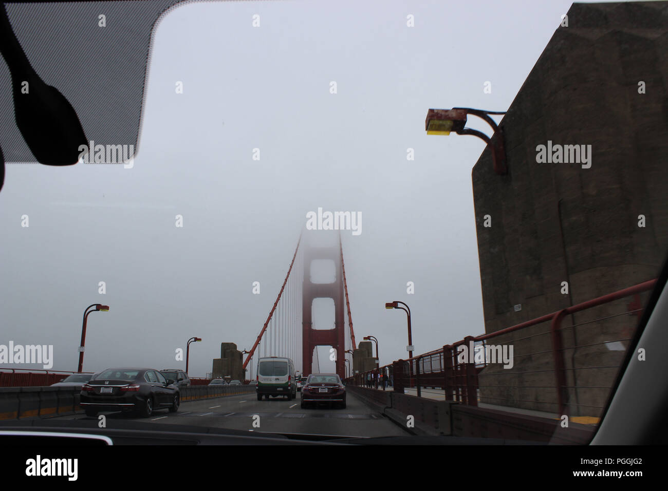 Driving across a foggy Golden Gate Bridge, San Francisco, CA, USA Stock Photo