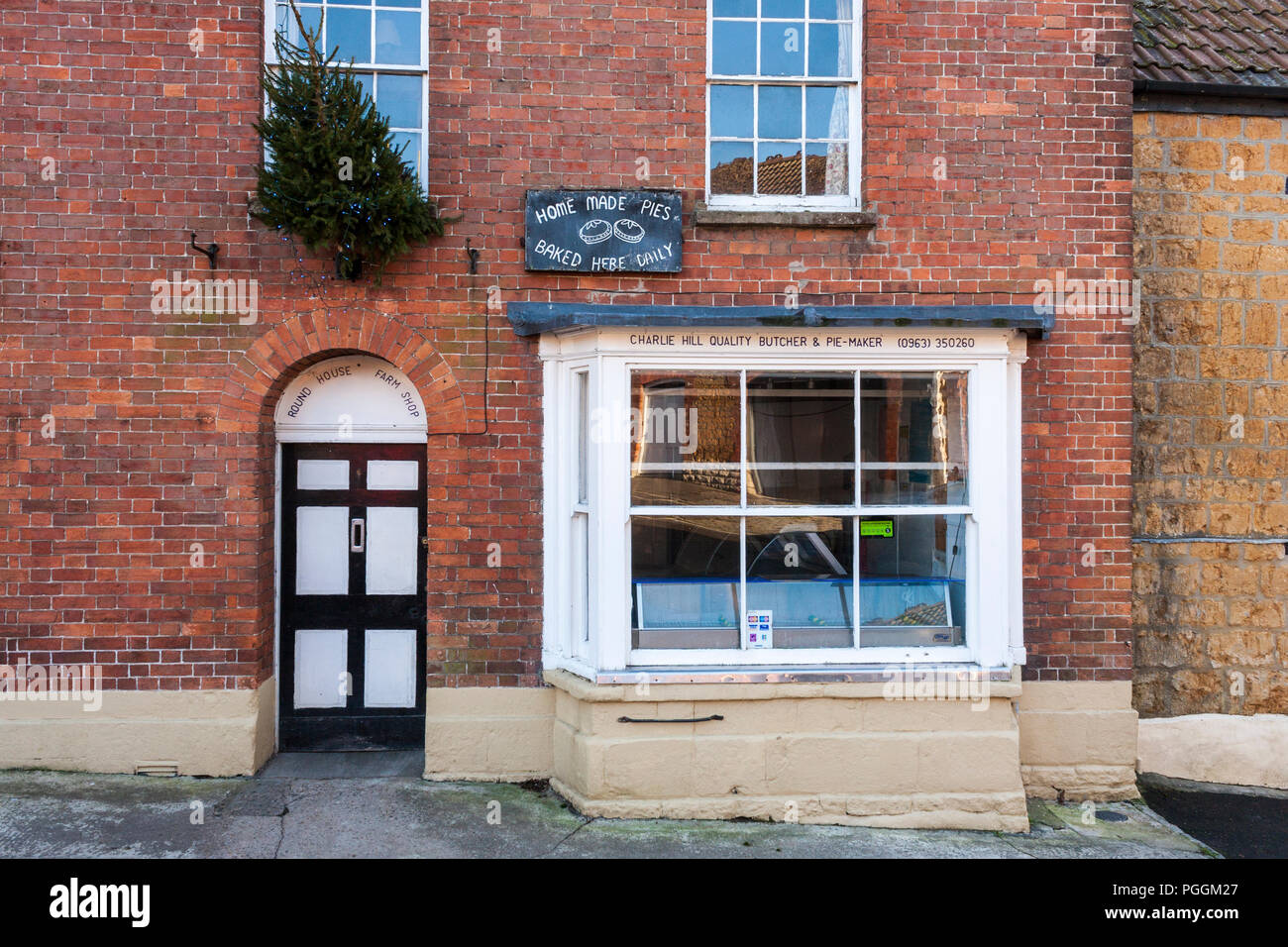 Village butcher's shop store front in country village of Castle Cary, Somerset, England, GB, UK. Stock Photo