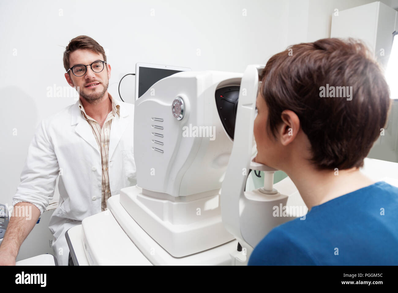 eye Doctor is measuring a patient's visual field with the OCT test
