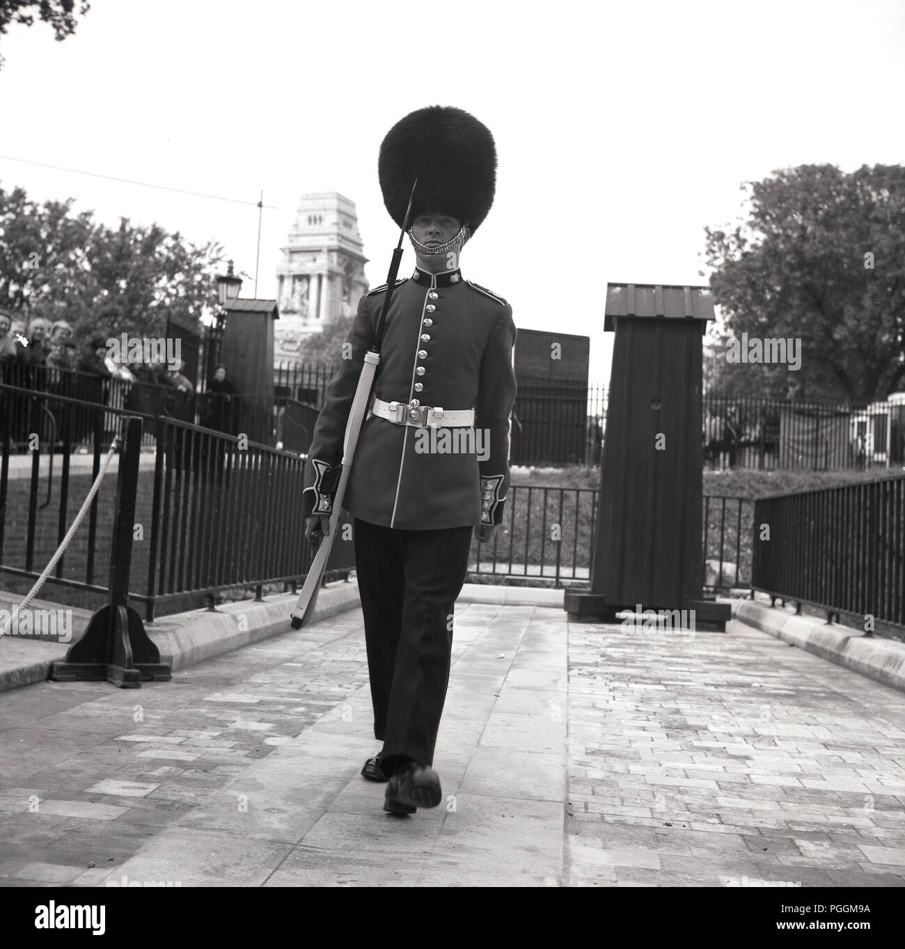 1960s, historical, A Queen's or Royal guardsman on sentry duty in his bearskin, with rifle, Tower of London, London, England, UK. Stock Photo