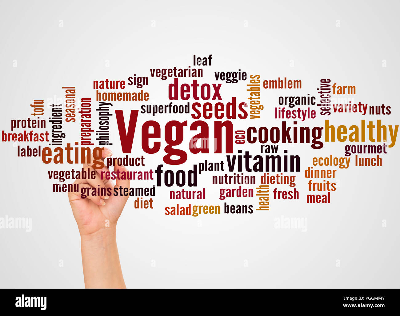 Vegan word cloud and hand with marker concept on gradient background. Stock Photo