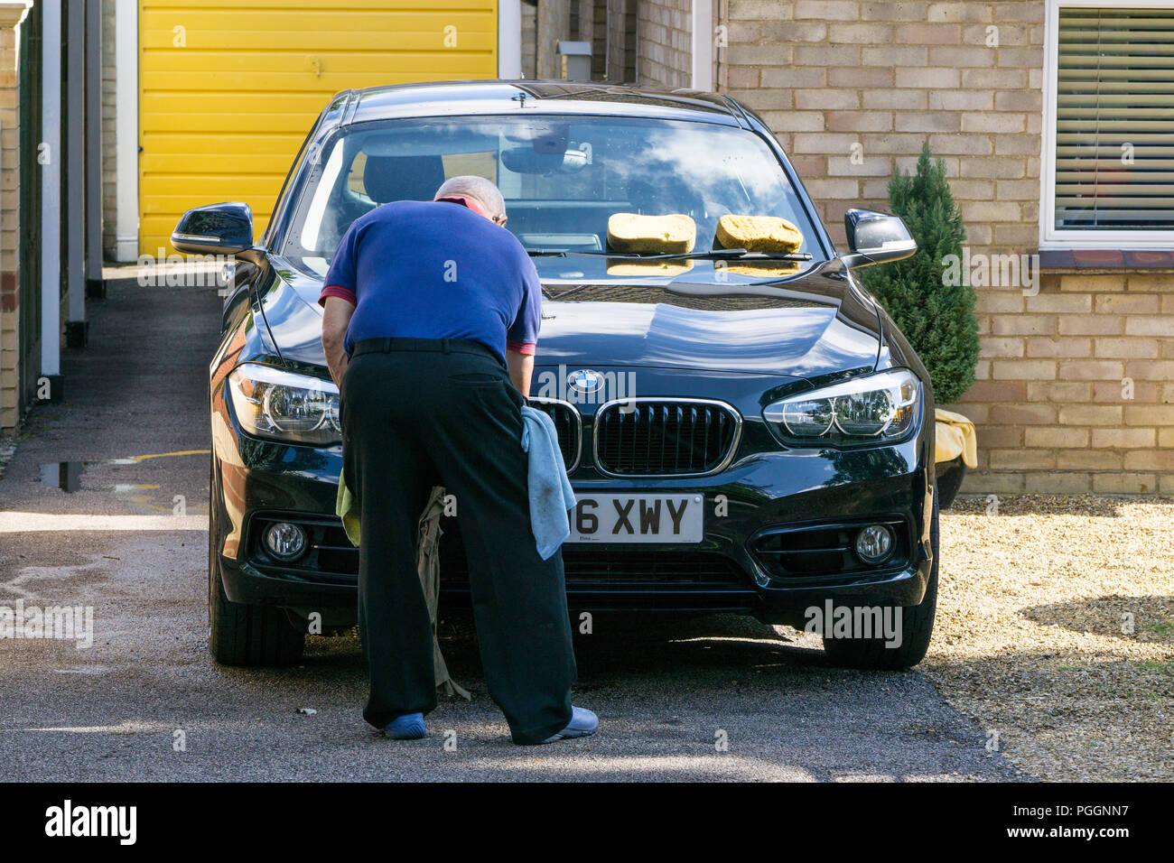 Man cleaning car in drive Stock Photo