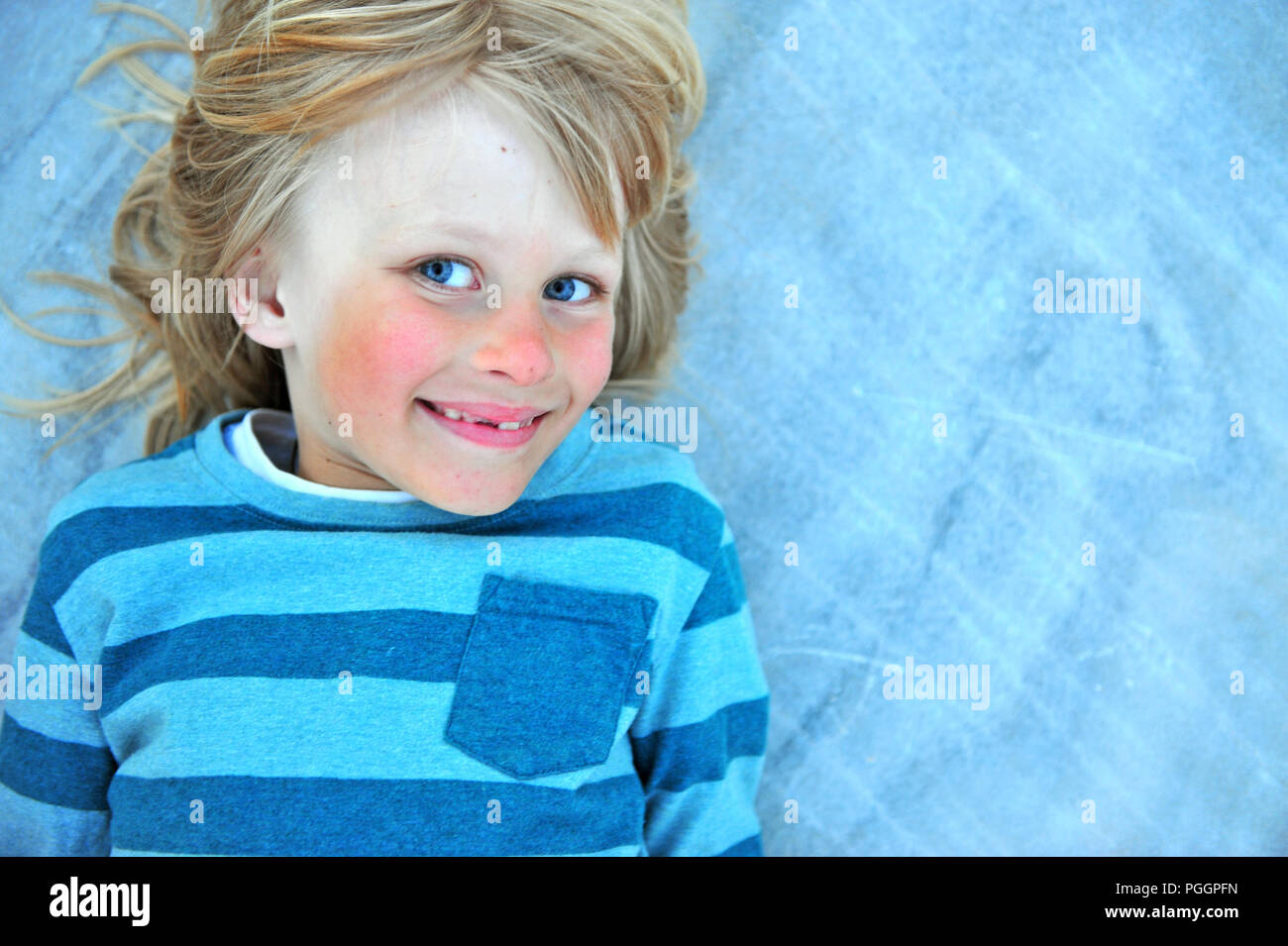 Portrat of sun-tanned kid, top view Stock Photo