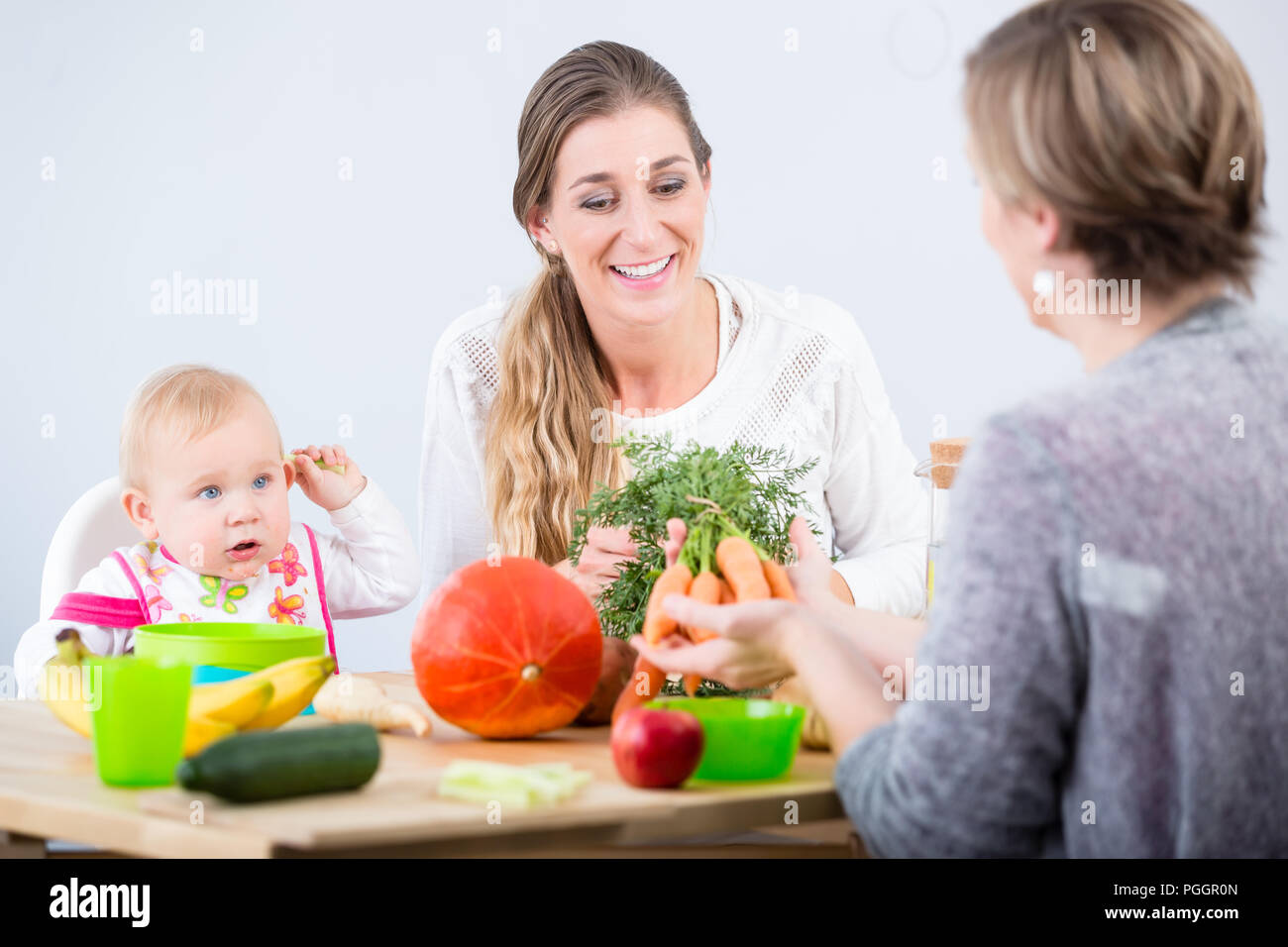Portrait of a cheerful mother learning from her best friend Stock Photo