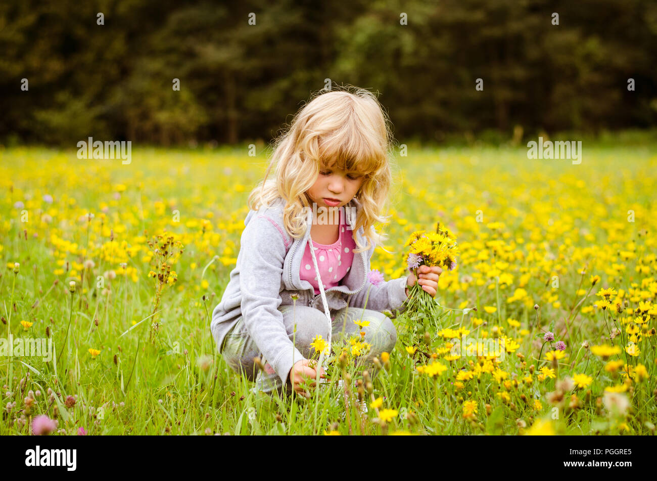 Happy girl on meadow flowers hi-res stock photography and images - Alamy