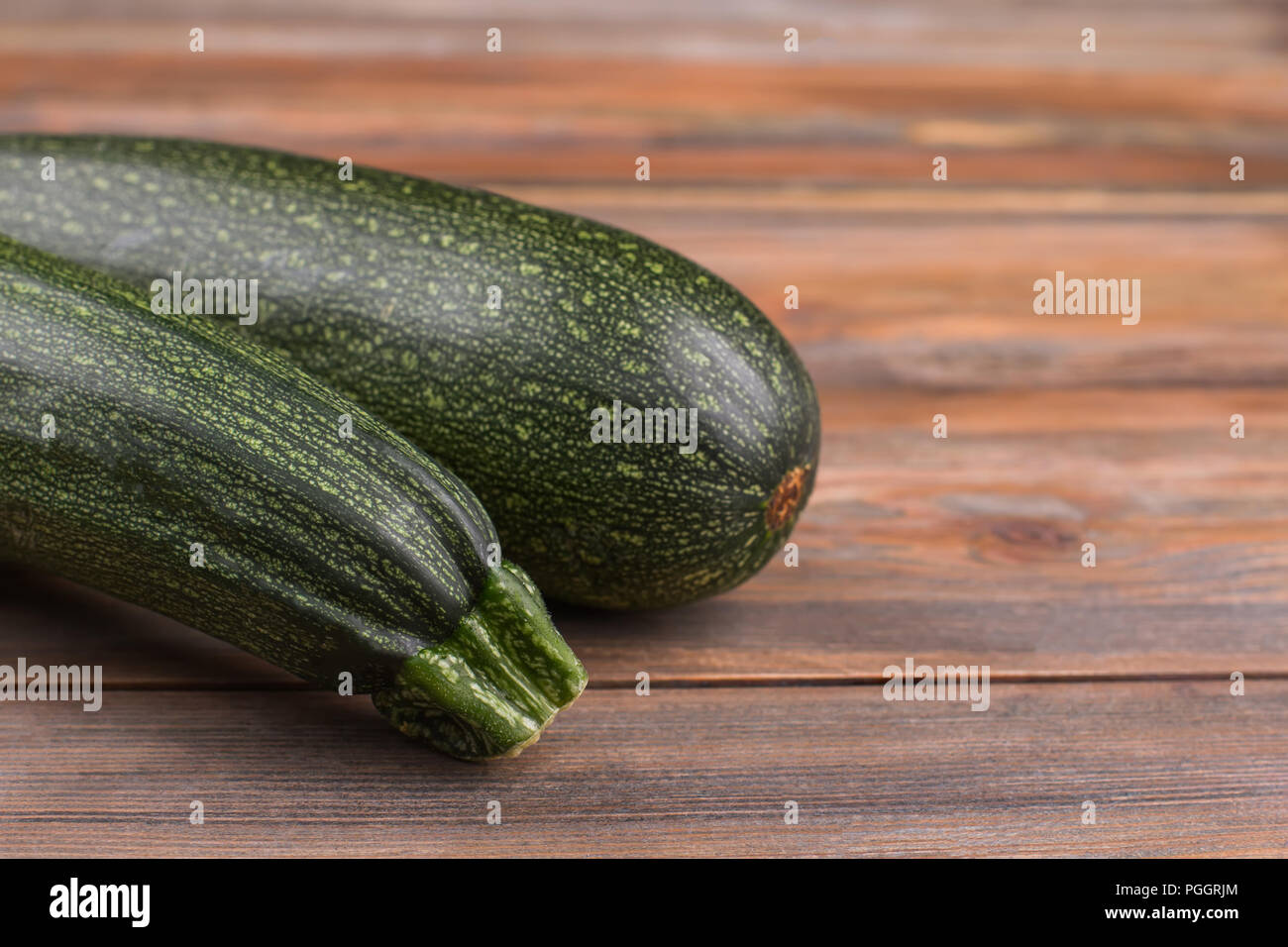 Courgette Black Beauty. Close Up. Brown Wooden Background. Stock Photo