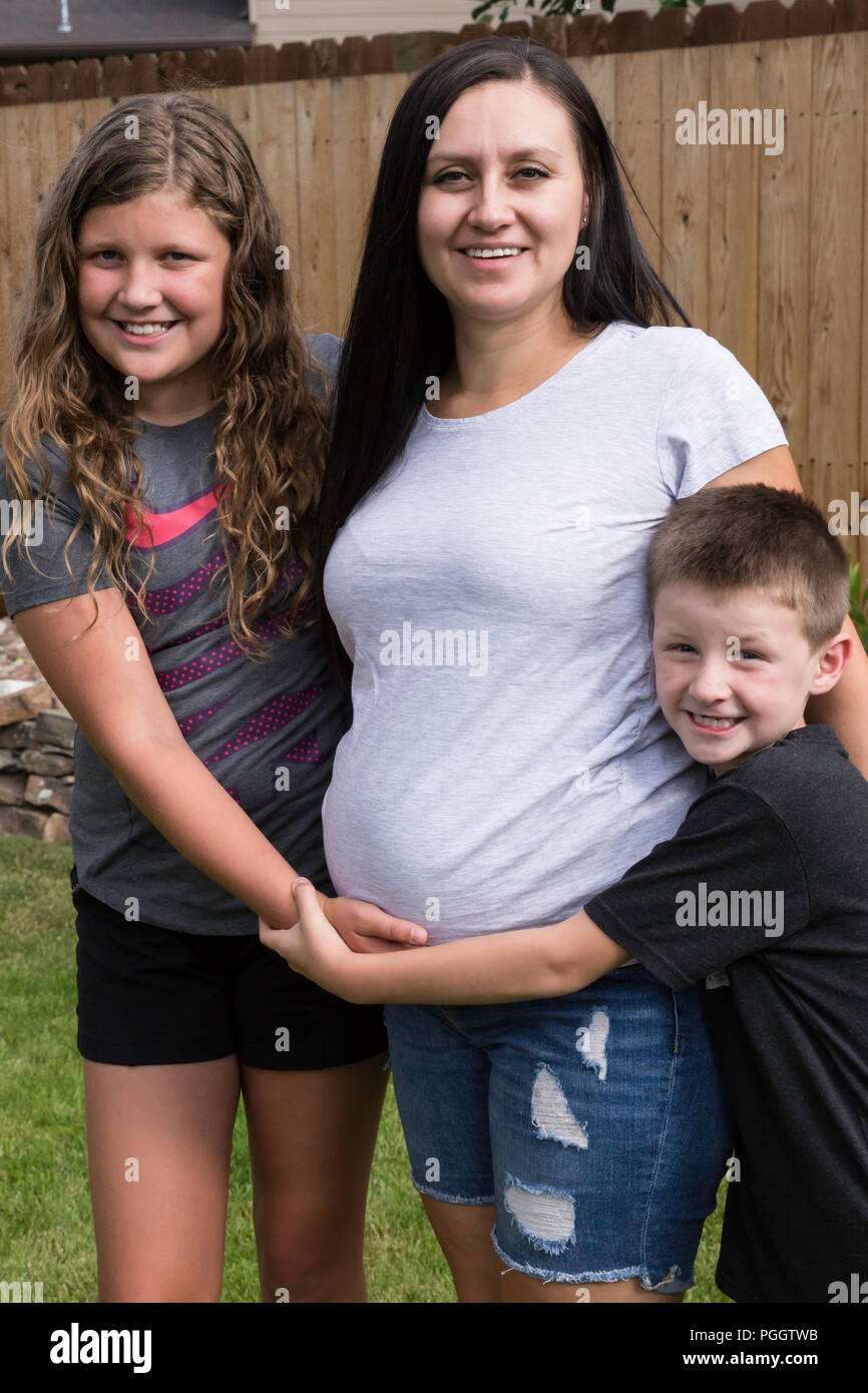 Pregnant Mother Poses with her children, MT, USA Stock Photo
