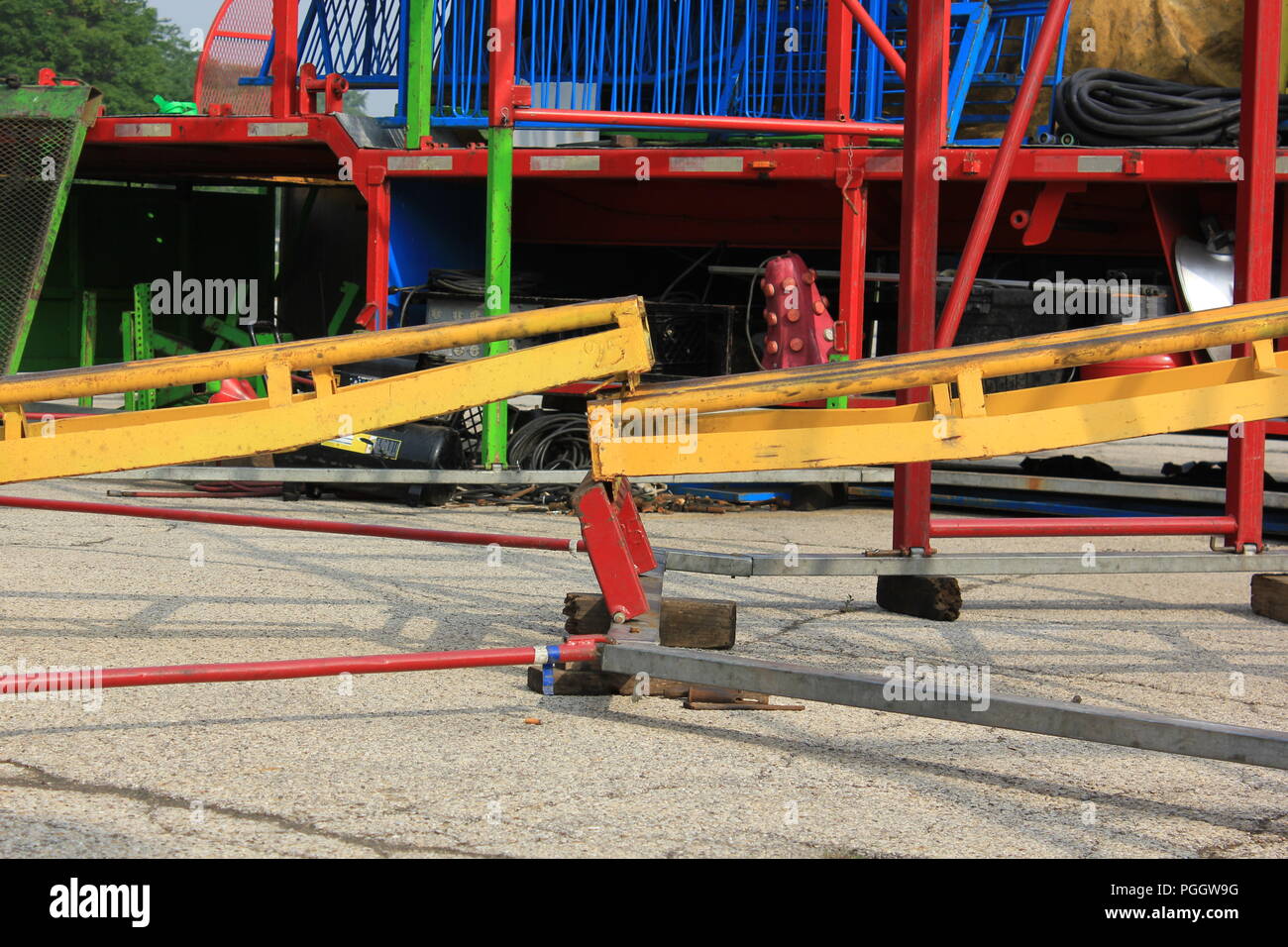 Disengaged or broken rail track for a Traveling kiddie carnival ride roller coaster under construction in a shopping mall parking lot in Niles, Illinois, USA on a sunny summer morning. Stock Photo