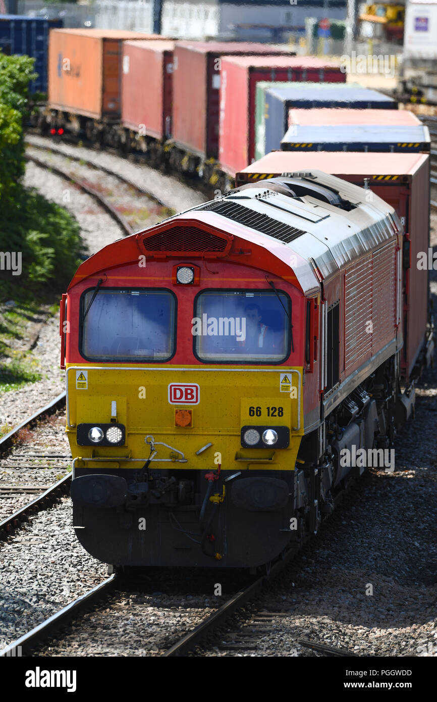 Container railway train travelling on the main line into Southampton ...
