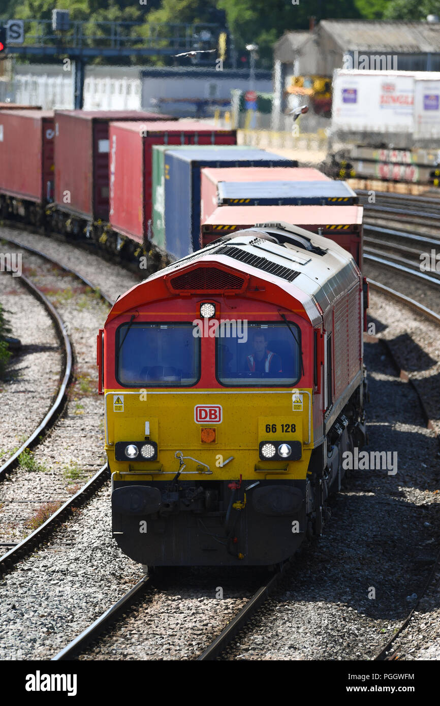 Container railway train travelling on the main line into Southampton ...