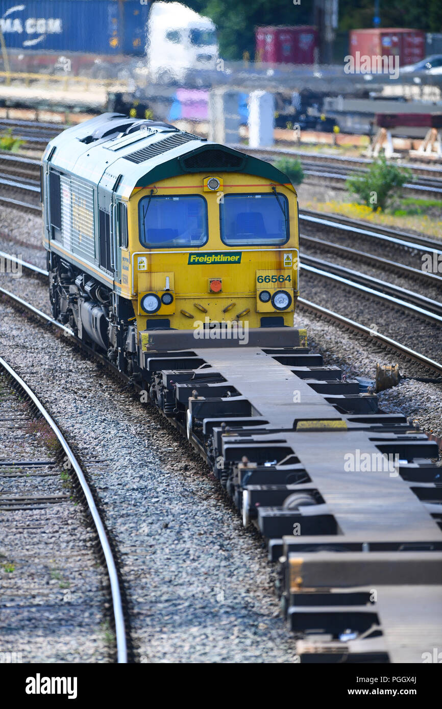 Container railway train travelling on the main line into Southampton ...