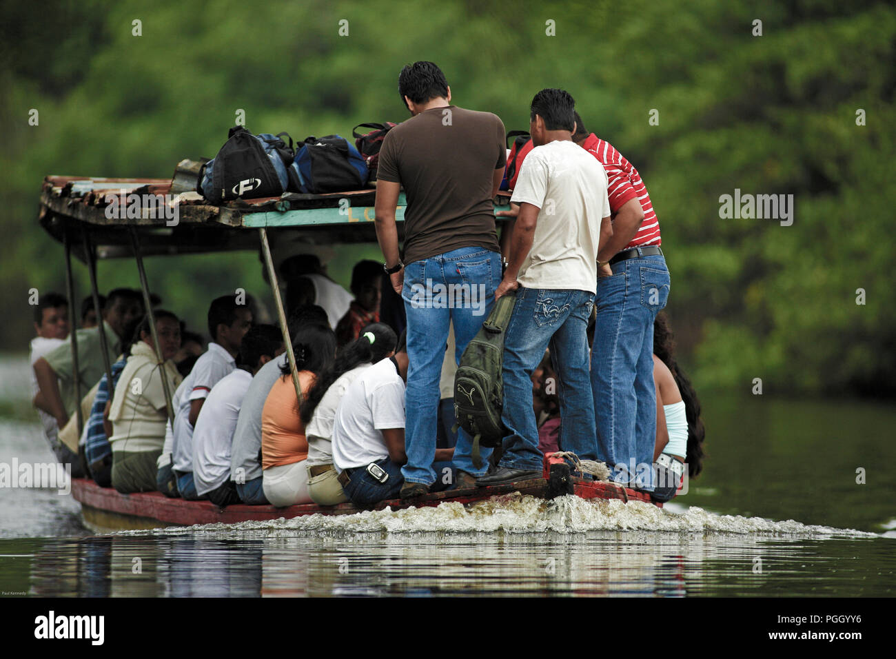 Small passenger boat with full capacity of passengers in Monterrico, Guatemala Stock Photo