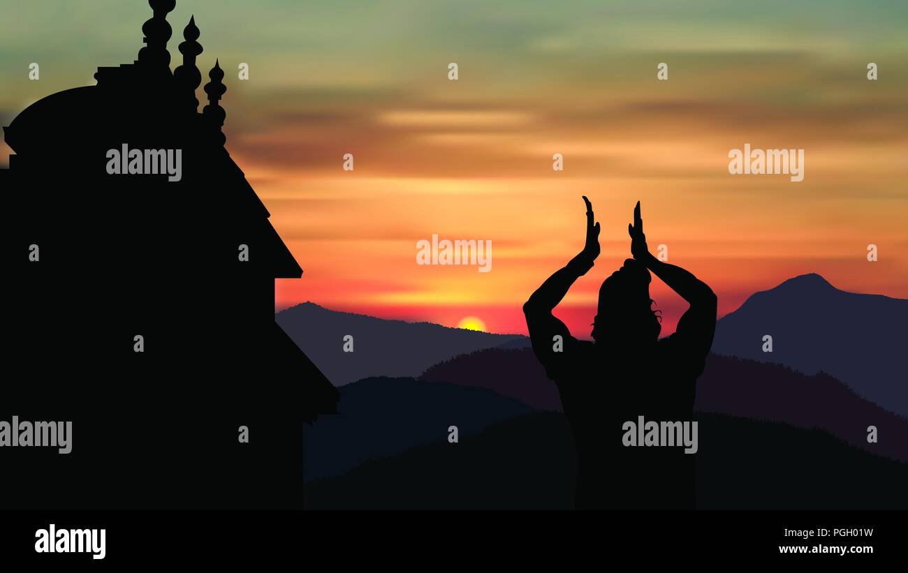 A priest bowing to rising sun in front of Badrinath temple as an Indian ritual Stock Photo