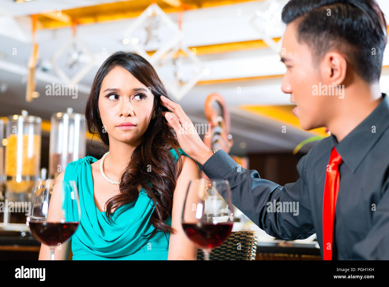 Asian couple sitting in restaurant Stock Photo