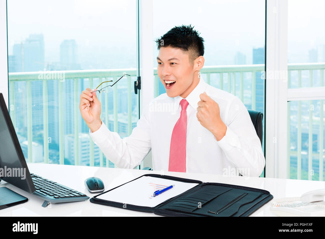 Asian broker trading at stock exchange in office Stock Photo