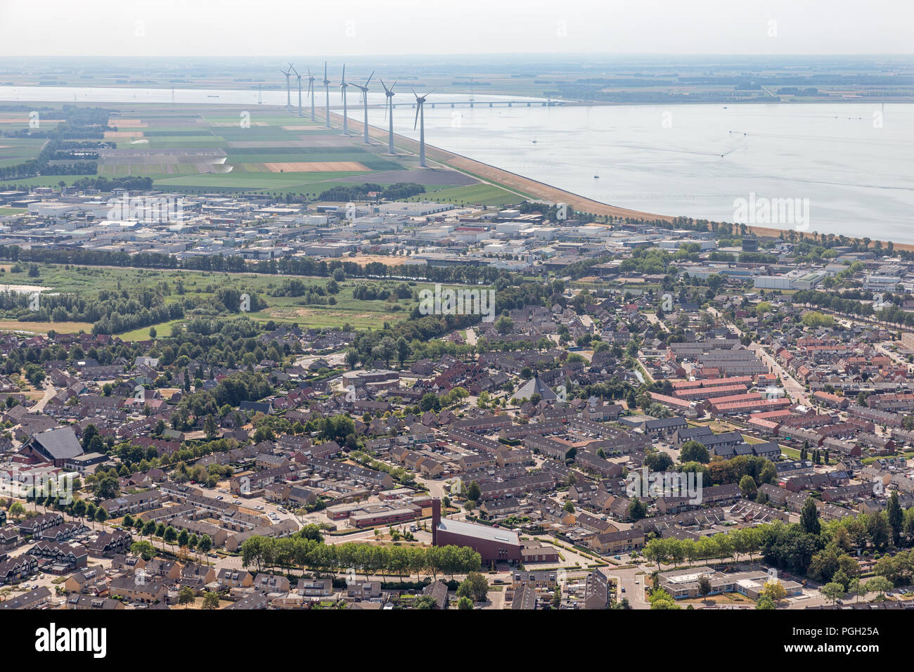 Aerial view Dutch fishing village with residential area and windturbines Stock Photo