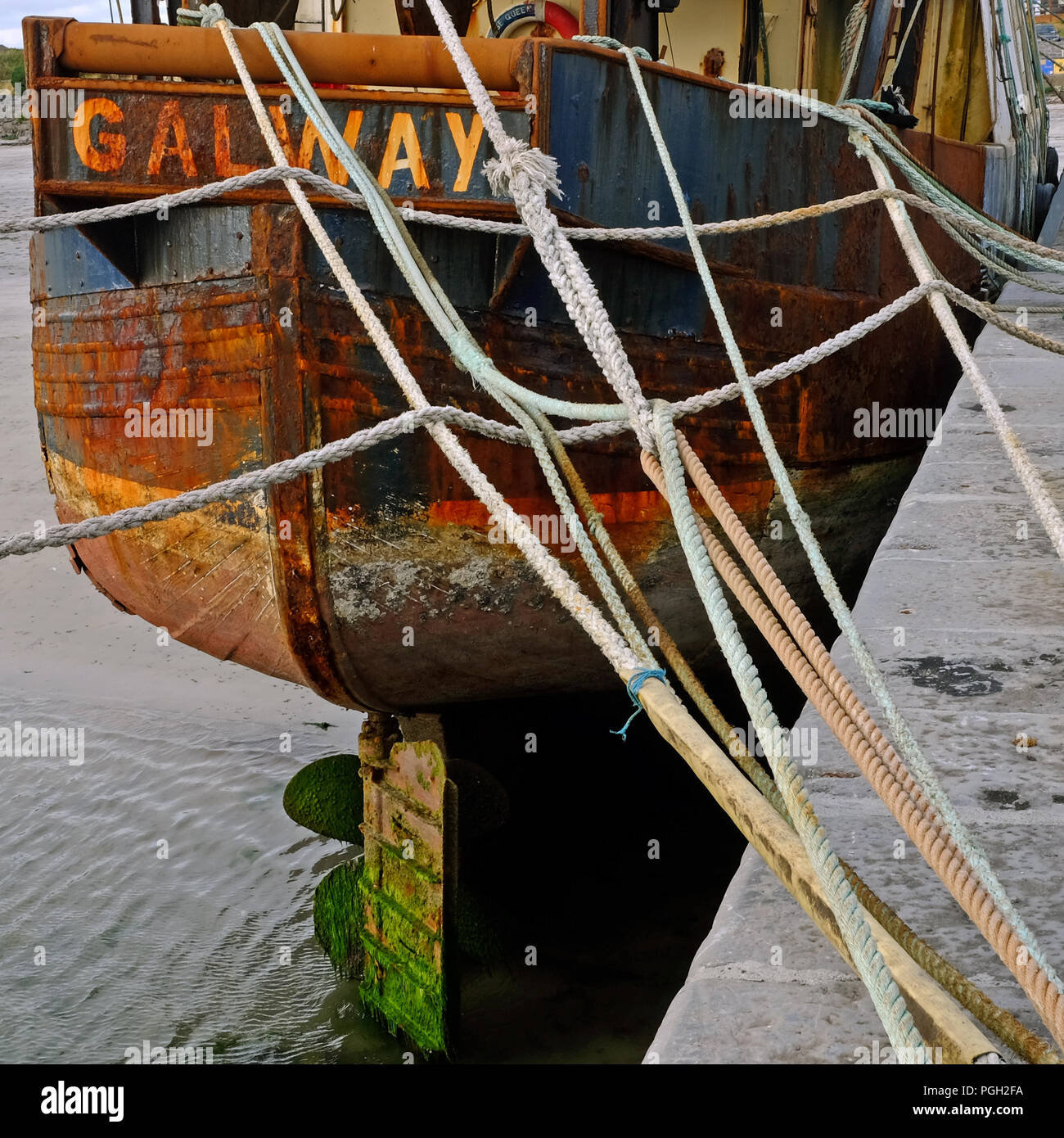 Rusting stern of the trawler 'Village Queen', Kilronan pier, Inishmore, Aran Islands. Stock Photo