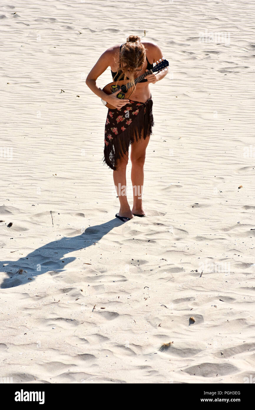 woman plays mandolin at the beach Stock Photo Alamy
