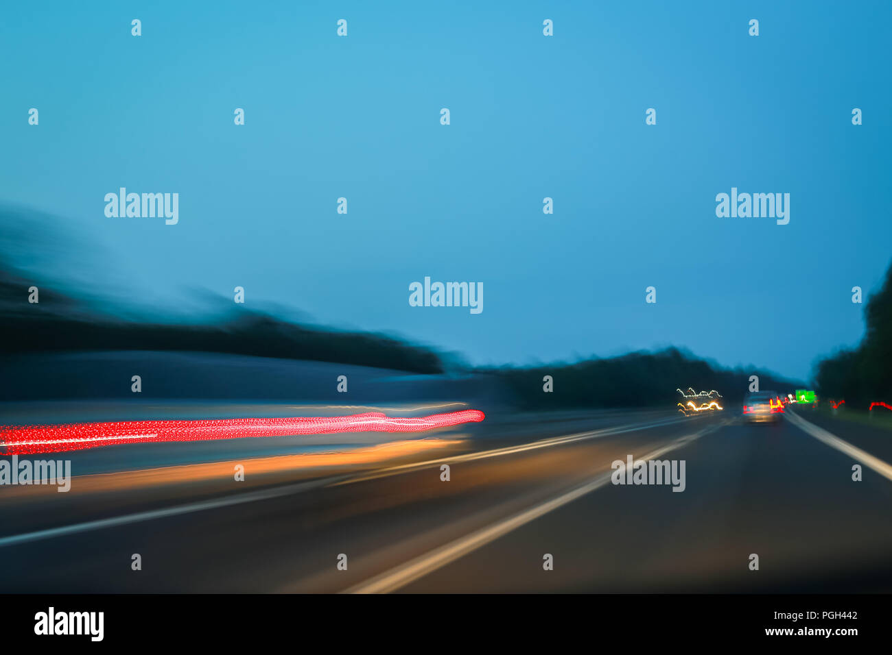 Abstract lines of traffic on highway at sunset. Stock Photo