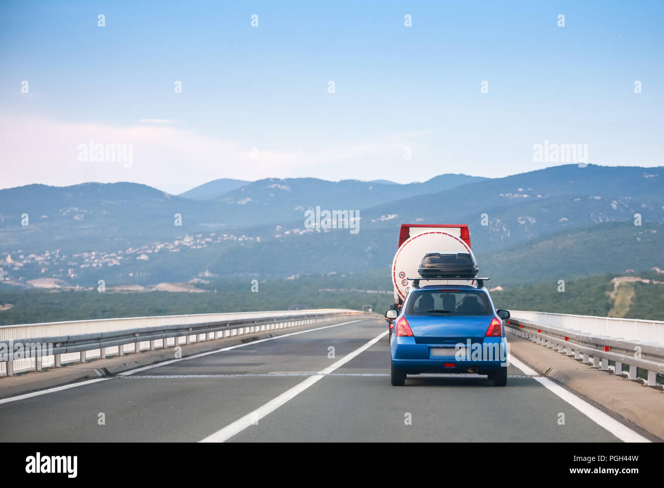 Rear view of car and tank truck driving over Krk brige in Croatia Stock Photo Alamy