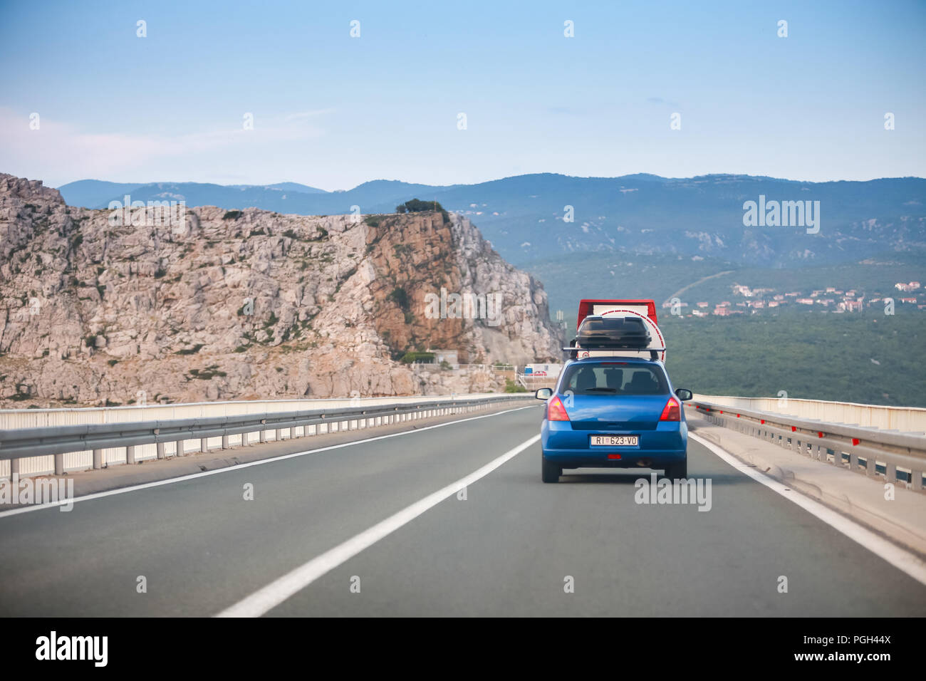 Rear view of car and tank truck driving over Krk brige in Croatia Stock Photo Alamy