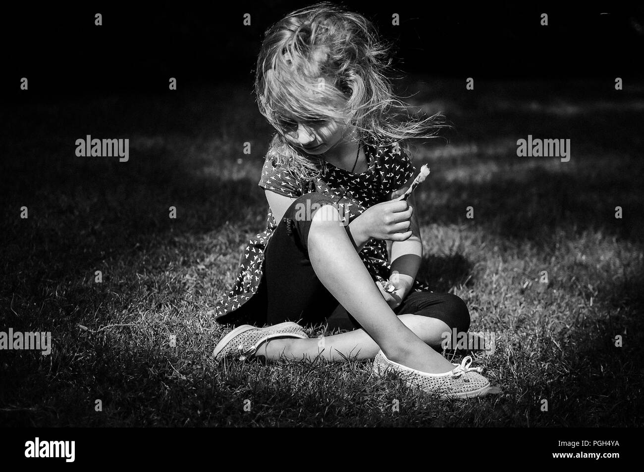 Funny Surprised Little Blonde Girl Screaming in the Park. Outdoors Portrait of Happy Acive Female Child. B W Stock Photo