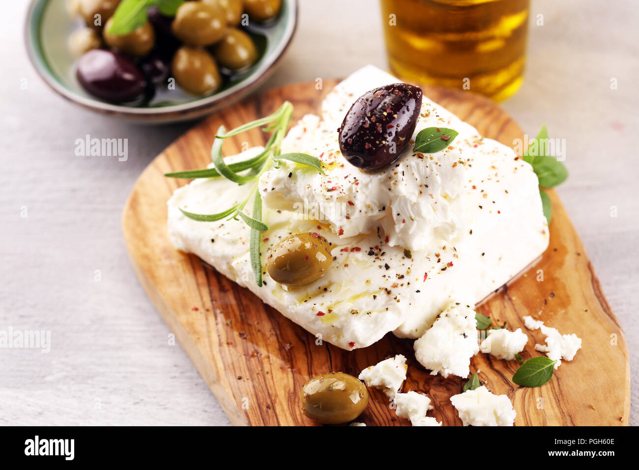 Greek Cheese Feta With Herbs And Olives On Rustic Table Stock Photo - Alamy