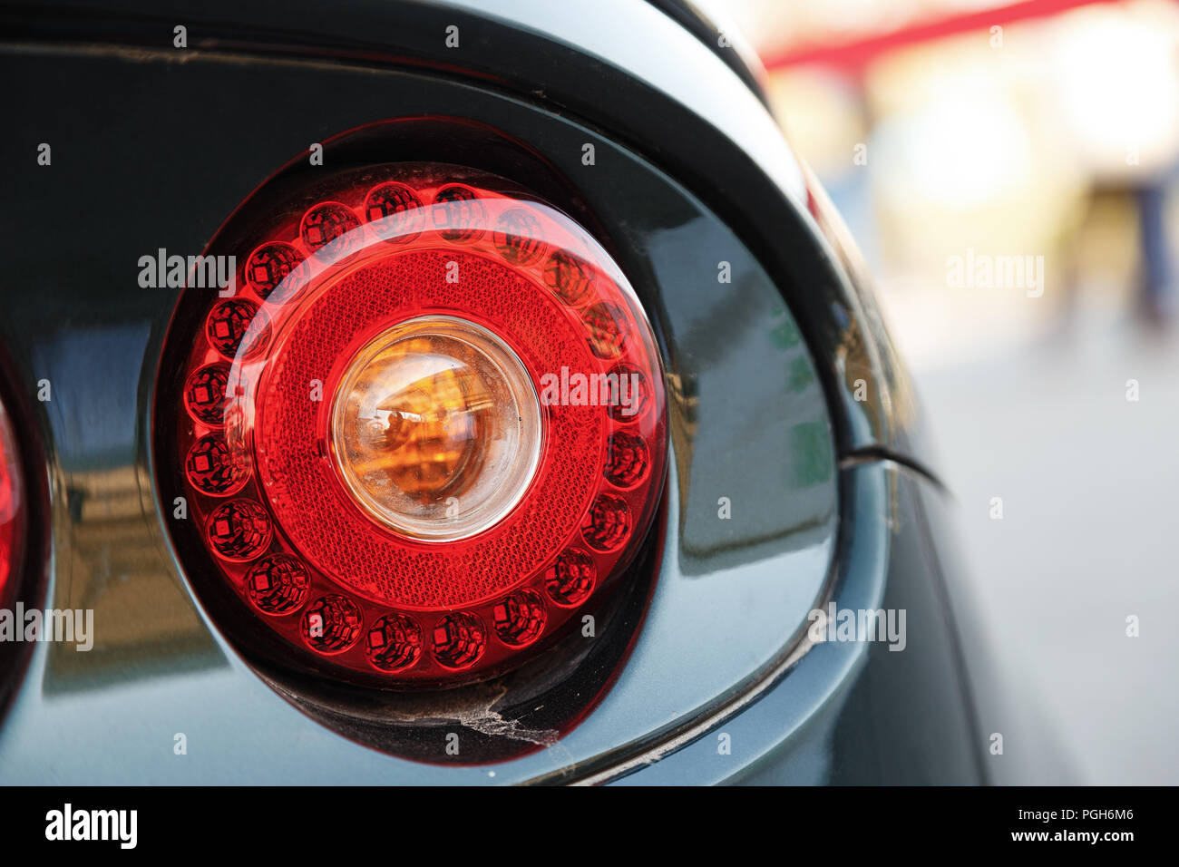 Red round back lights on a black car Stock Photo Alamy