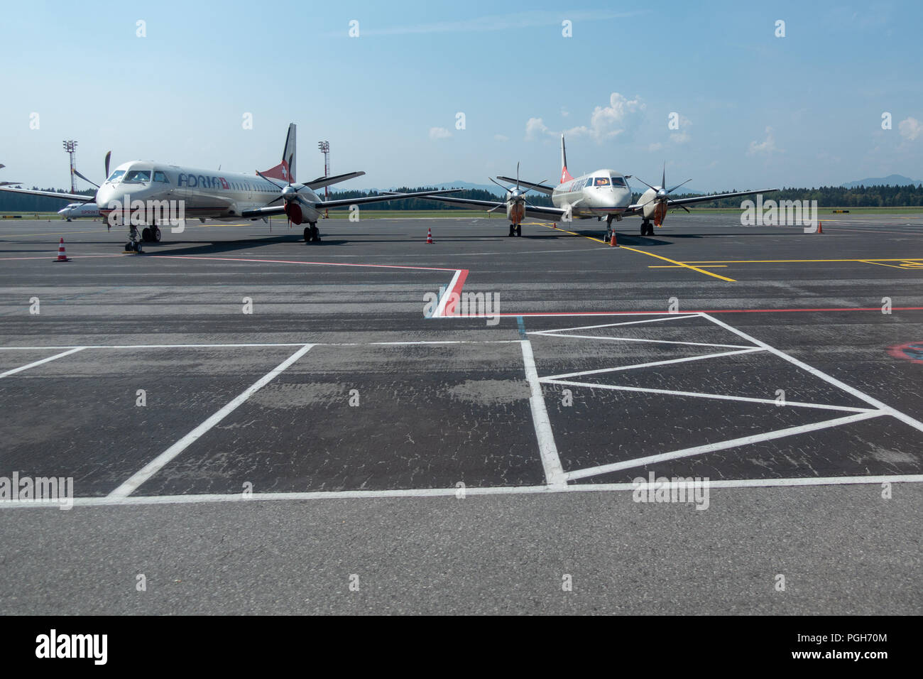 Brnik, Slovenia - August 23 2018: Remains of Darvin Air SA flying as Adria Airways Switzerland. Two SAAB 2000 aircraft on tarmac are left after compan Stock Photo