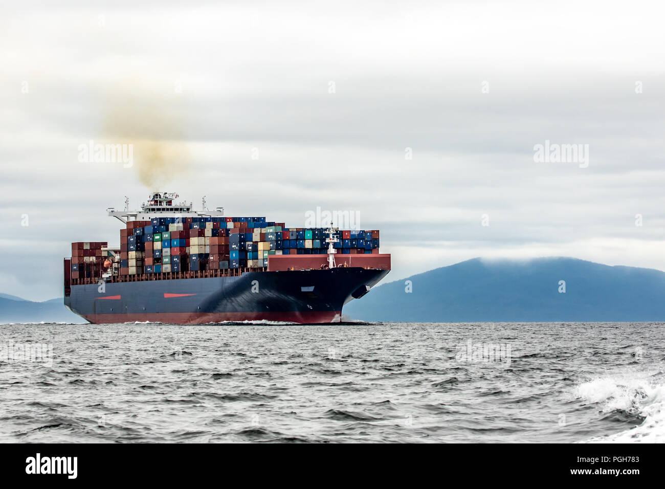 Cargo Ship Freighter carrying Cargo containers in a shipping lane on the the San Juan Islands  near Vancouver. Stock Photo