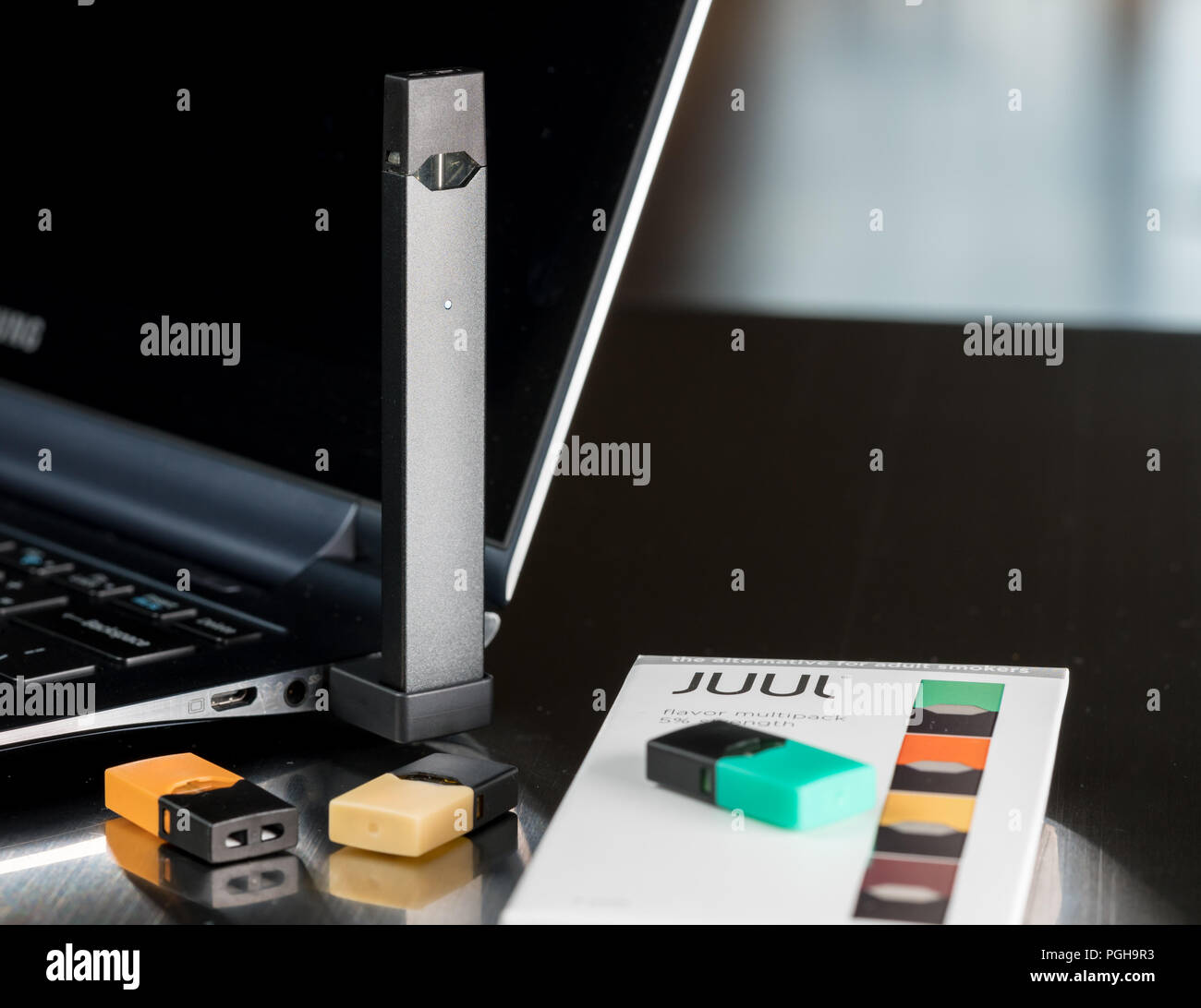JUUL nicotine dispenser beng charged with pods Stock Photo Alamy