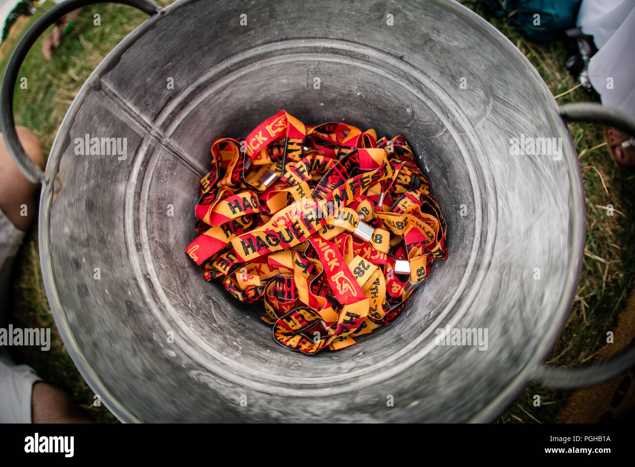 Pile of festival party wristbands inside of metal bucket Stock Photo