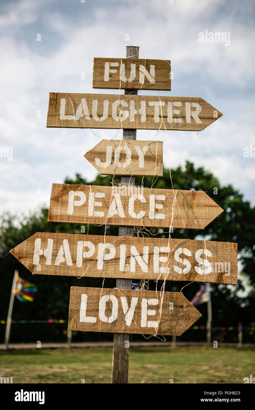 Wooden joy, peace, love and happiness sign at DIY garden wedding ...