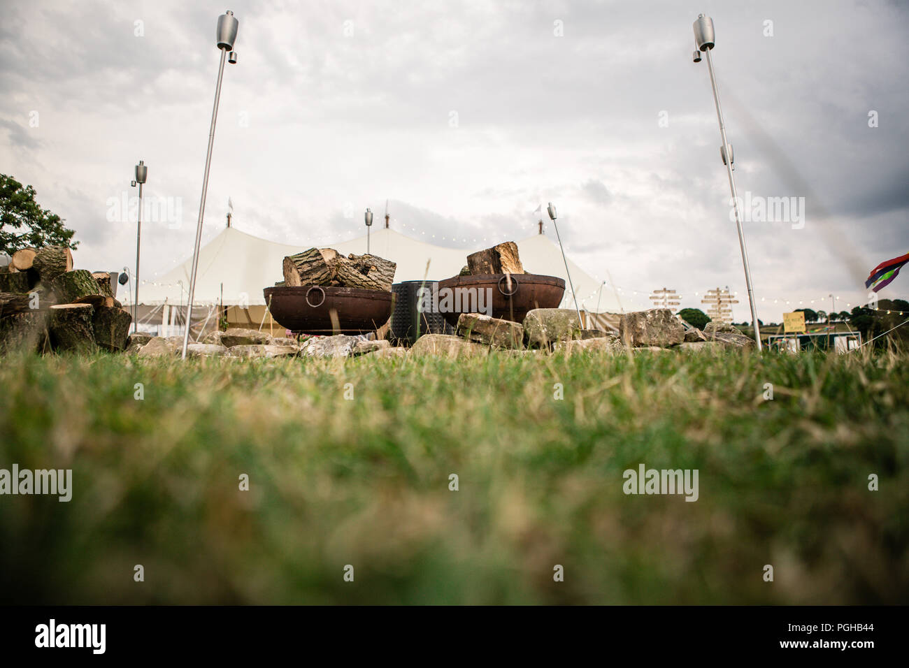 Outdoor log burning fire pit and logs before they are lit at festival