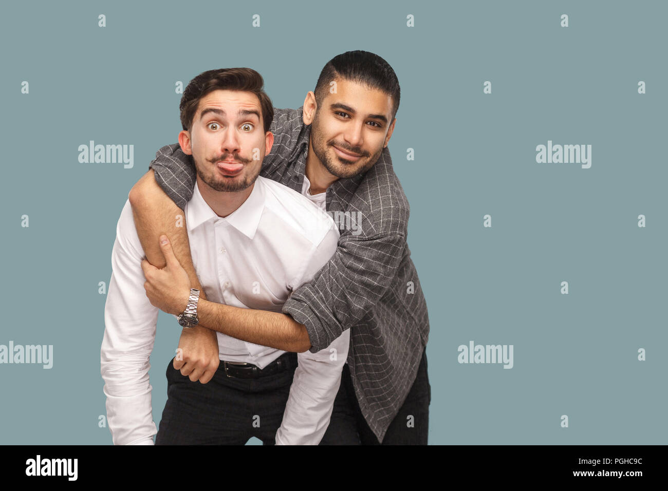 portrait of two handsome happy bearded friends standing, enjoying ...