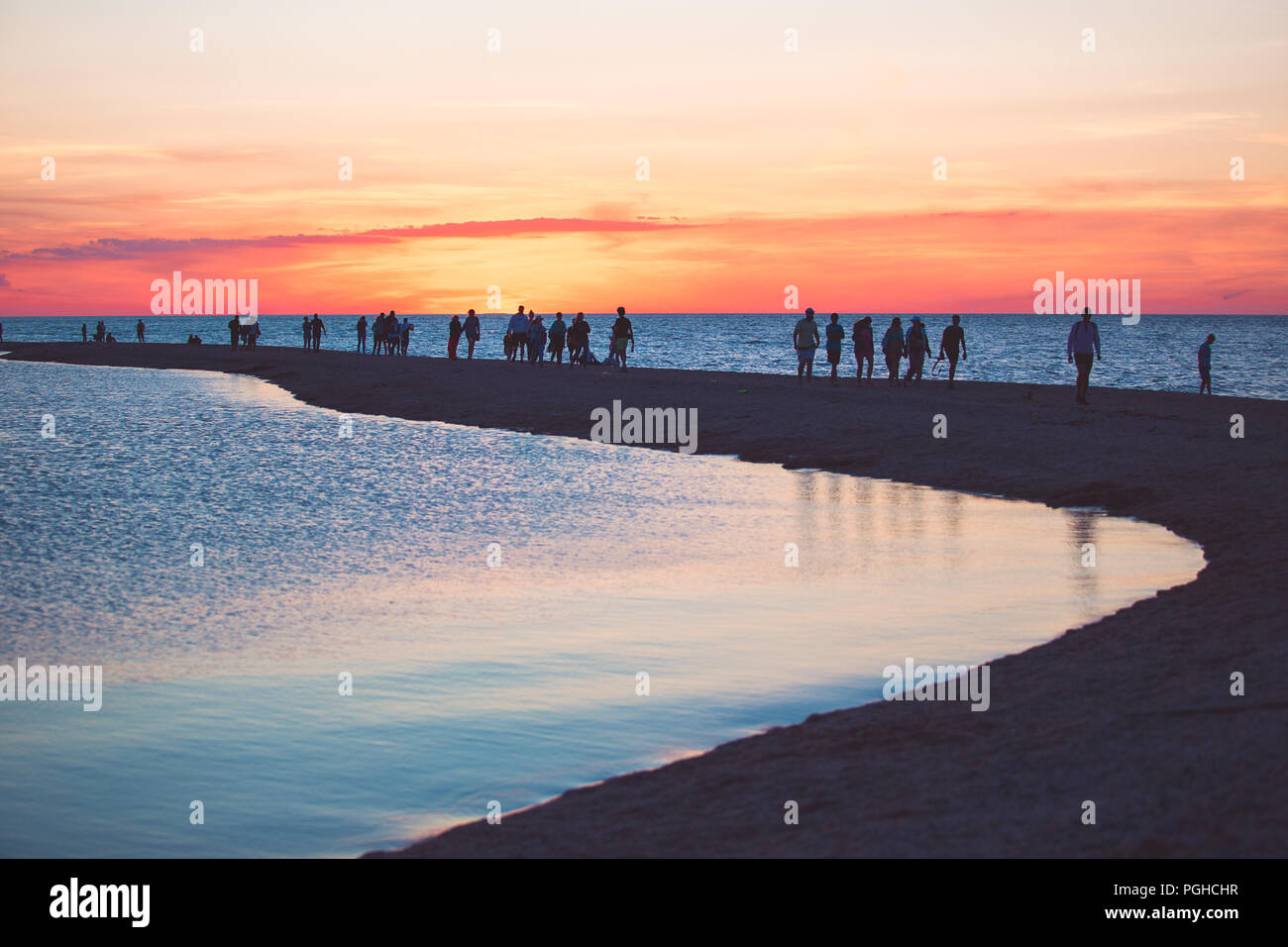 Beautiful seascape with people watching the sunset over the sea. Stock Photo