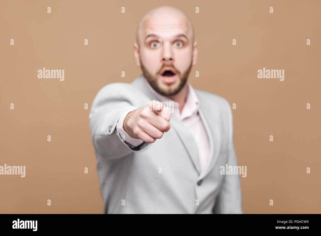 Portrait Of Amazed Handsome Middle Aged Bald Bearded Businessman In