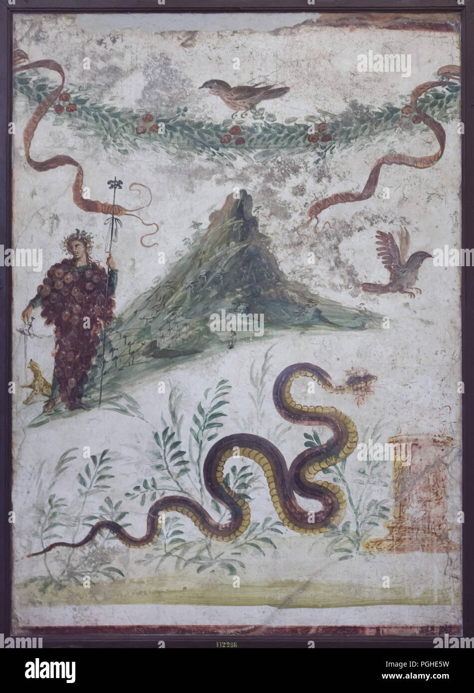Bacchus and Mount Vesuvius depicted in the Roman fresco from the House of the Centenary (Casa del Centenario) in Pompeii, now on display in the National Archaeological Museum (Museo Archeologico Nazionale di Napoli) in Naples, Campania, Italy. Stock Photo