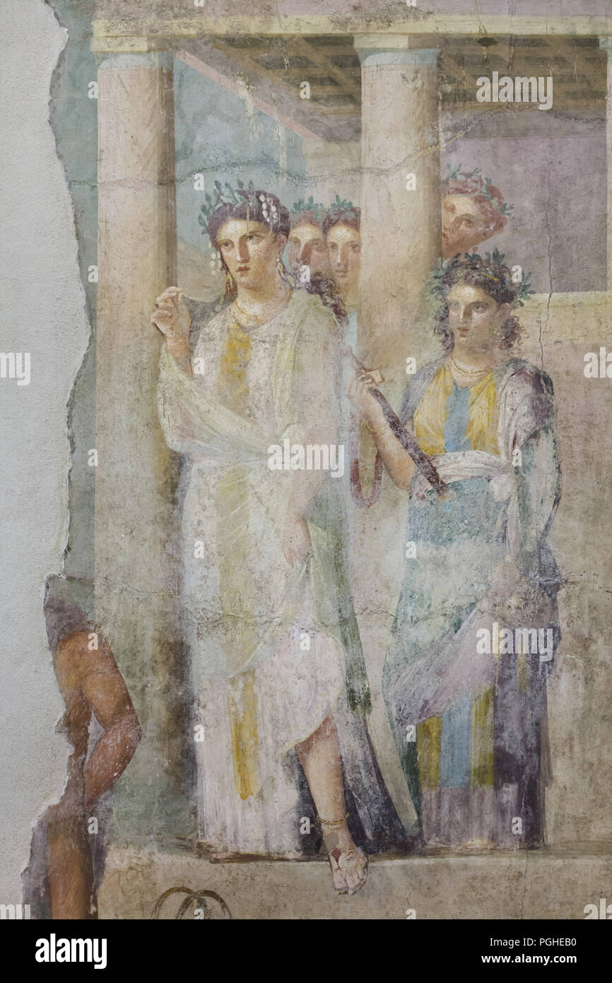 Iphigenia surrounded by assistants depicted as the priestess of the Taurian Artemis in the Roman fresco from the House of Lucius Caecilius Iucundus (Casa di Lucio Cecilio Giocondo) in Pompeii (1-79 AD), now on display in the National Archaeological Museum (Museo Archeologico Nazionale di Napoli) in Naples, Campania, Italy. Iphigenia, in the solemn dress of the priestess of the Taurian Artemis, leaves the temple surrounded by assistants to greet the young prisoners (only part of their figures remains). Among them she will discover her brother Orestes and his faithful friend Pylades. Stock Photo