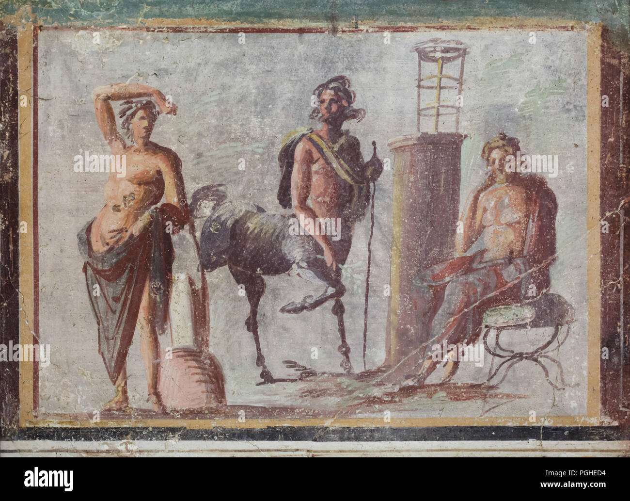 Centaur Chiron stands between Apollo on the left and Asclepius on the right depicted in the Roman fresco dated from the 1st century BC on display in the National Archaeological Museum (Museo Archeologico Nazionale di Napoli) in Naples, Campania, Italy. Centaur Chiron, inventor of medicine and surgery, taught them the art of medicine. Stock Photo