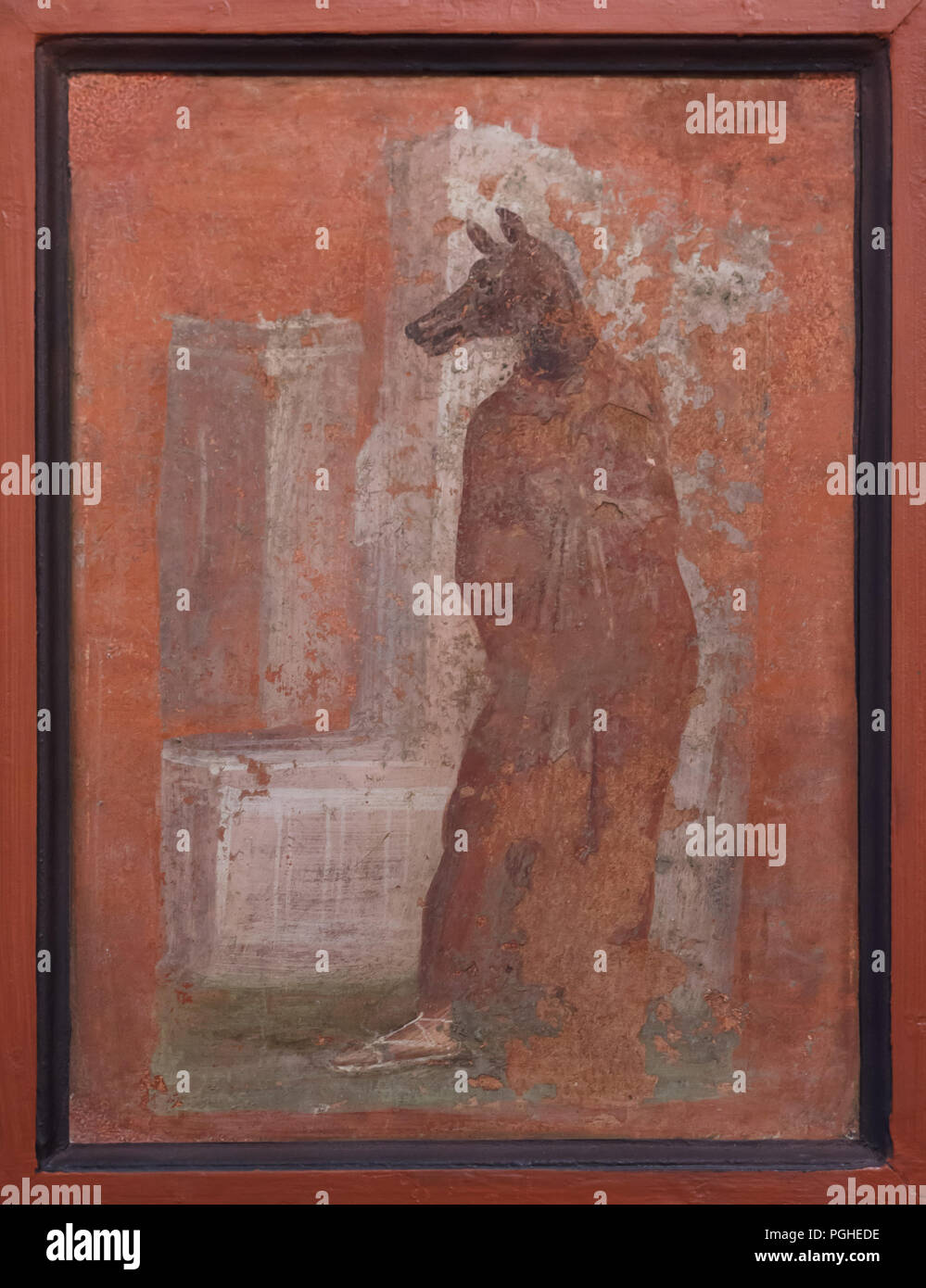 Priestess wears the Anubis mask depicted in the Roman fresco from the ekklesiasterion of the Temple of Isis (Tempio di Iside) in Pompeii, now on display in the National Archaeological Museum (Museo Archeologico Nazionale di Napoli) in Naples, Campania, Italy. Stock Photo