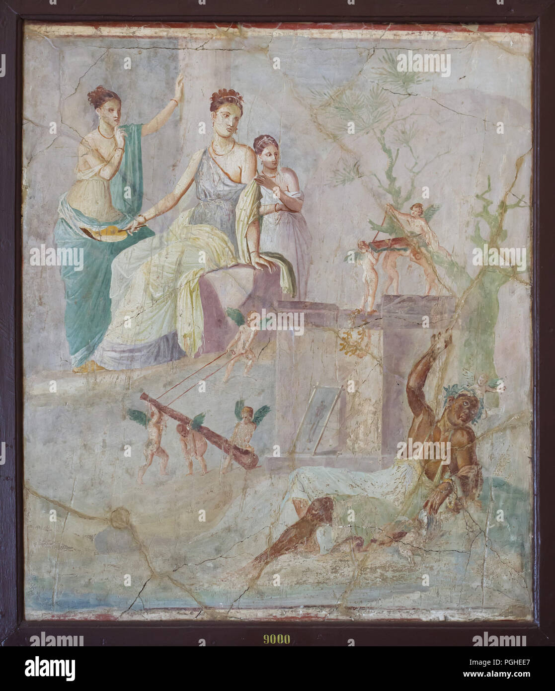 Hercules and Omphale depicted in the Roman fresco from the House of the Prince of Montenegro (Casa del Principe di Montenegro) in Pompeii (40-60 AD), now on display in the National Archaeological Museum (Museo Archeologico Nazionale di Napoli) in Naples, Campania, Italy. The Lydian Queen Omphale, depicted holding a leaf-fan, looks down at drunken Hercules with a bemused expression; her tunic slips off of her left shoulder in the manner of Venus. She is flanked by two young girls. Hercules wearing a woman's dress and a wreath on his head reclines drunkenly below. Cupids play with his club, whil Stock Photo
